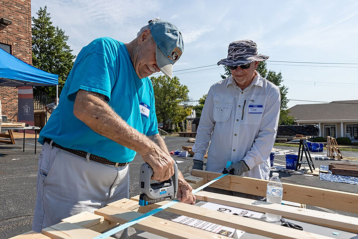 Al Boedges of Wildwood, left, and Tom Heard of Fenton help assemble children’s beds as part of the Sleep in Heavenly Peace project at The River Church in Eureka on Sept. 13.